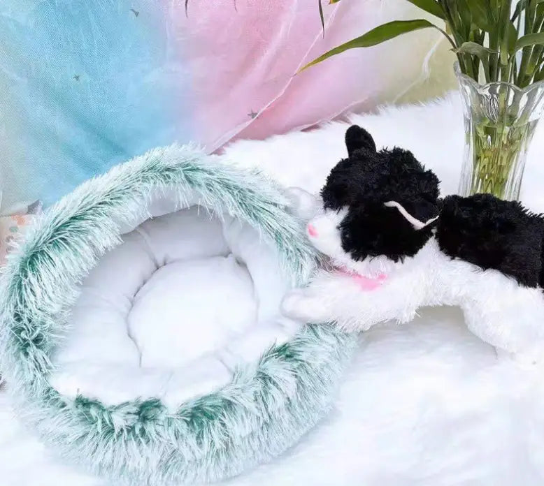 a plush mint-green faux-fur round plush warm cat bed pet with a soft white interior designed as a comfortable bed pet for cats