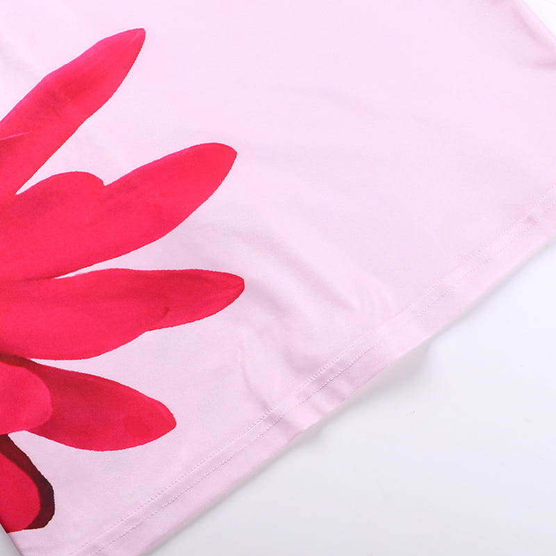 A soft pink fabric pink floral American style flower strap dress featuring a bold vibrant red flower print with layered petals.