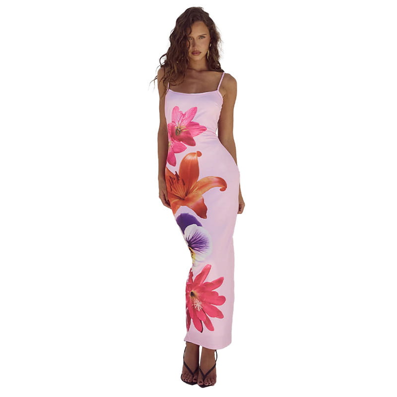 a flowing pink spaghetti strap maxi dress featuring vibrant floral prints in shades of magenta orange and purple designed in american style flower strap dress style.