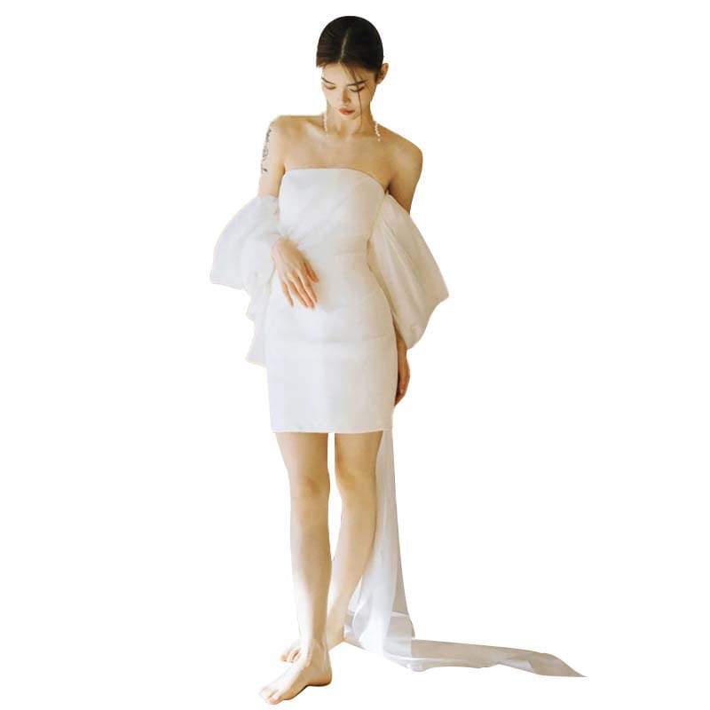 White off the shoulder mini light wedding dress with sheer voluminous sleeves and a flowing train designed as a small light wedding dress.