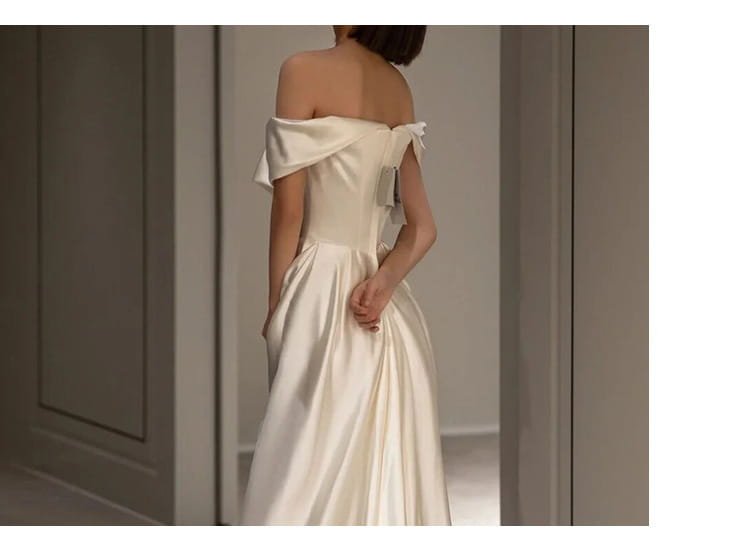 Off-the-shoulder french white satin wedding dress featuring a fitted bodice and flowing skirt in a light wedding dress design.