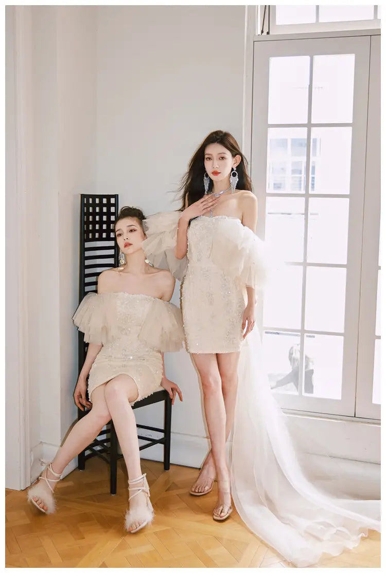 Off-white strapless ruffled mini dress with sheer overlay and beaded embellishments featuring a cinched waist miniskirt fairy design.