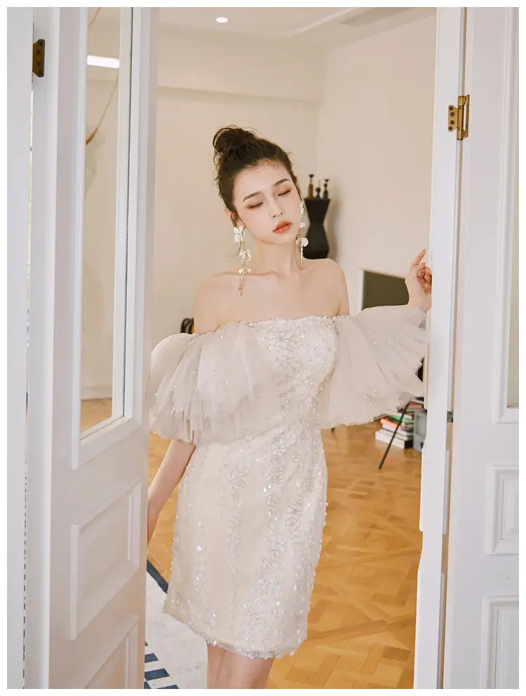 a shimmering off-the-shoulder ivory lace cinched waist miniskirt fairy dress with delicate beading and voluminous sheer sleeves