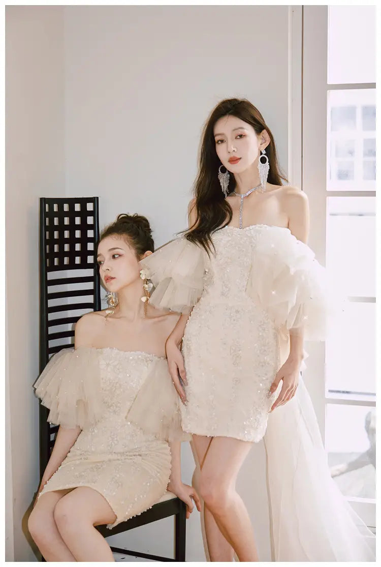 off-the-shoulder ruffled mini dress in shimmering ivory with delicate sequin detailing and sheer overlay fabric featuring a cinched waist miniskirt fairy design
