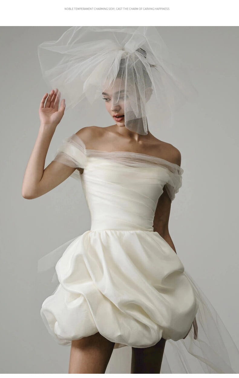 off-shoulder white satin mini wedding dress with a puffed skirt and matching sheer veil designed as a light wedding dress white with a tulle train
