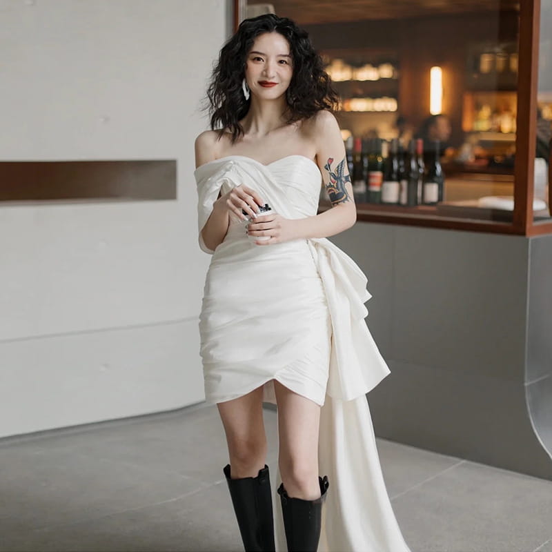 white off-the-shoulder mini dress with ruffled asymmetrical hem and draped side detail designed as a light wedding gown and wedding gown short for women