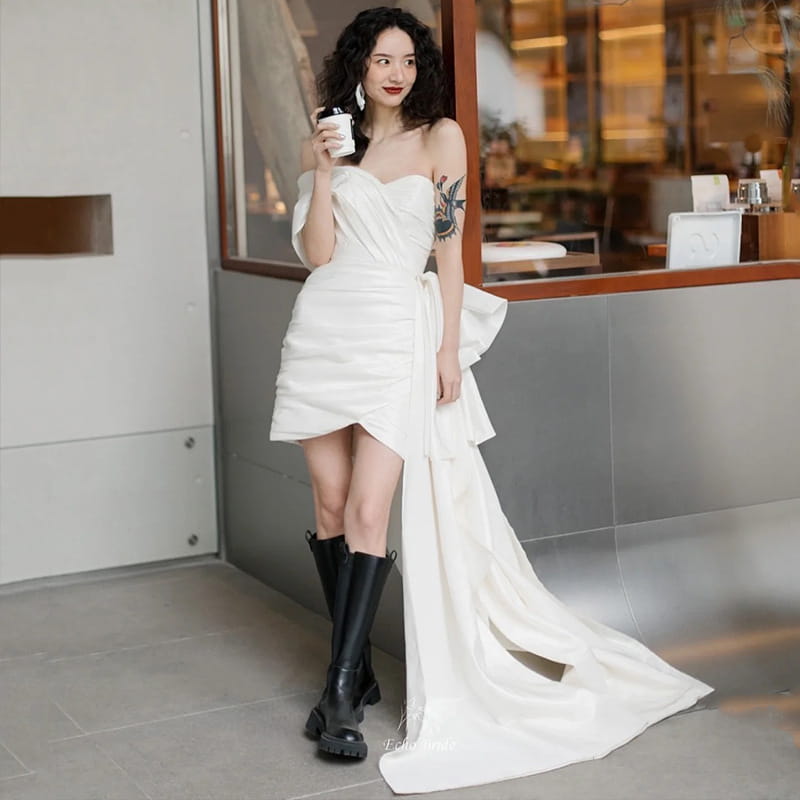 White off-the-shoulder wedding gown short with a side slit and flowing train designed as a light wedding gown short for women.