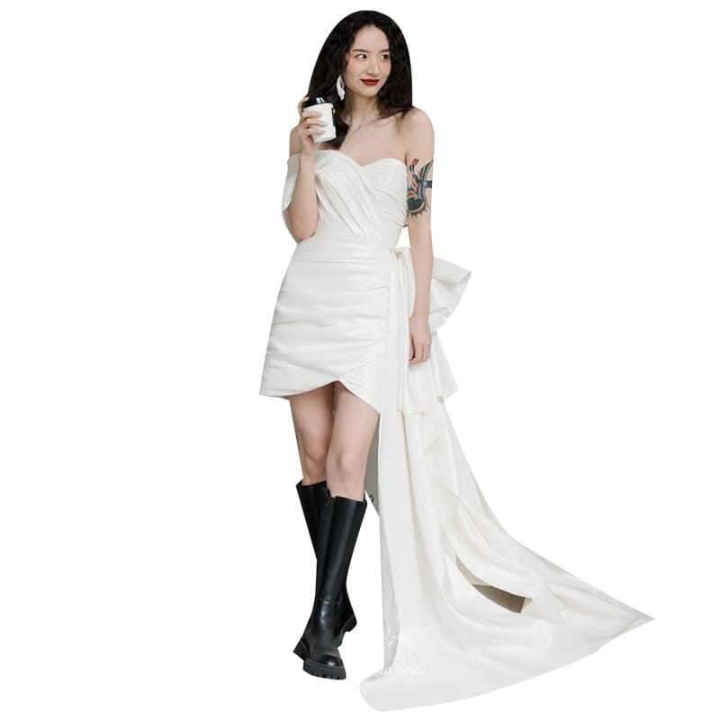 White satin strapless wedding gown short with a flowing train and asymmetrical hemline designed as a light wedding gown for women