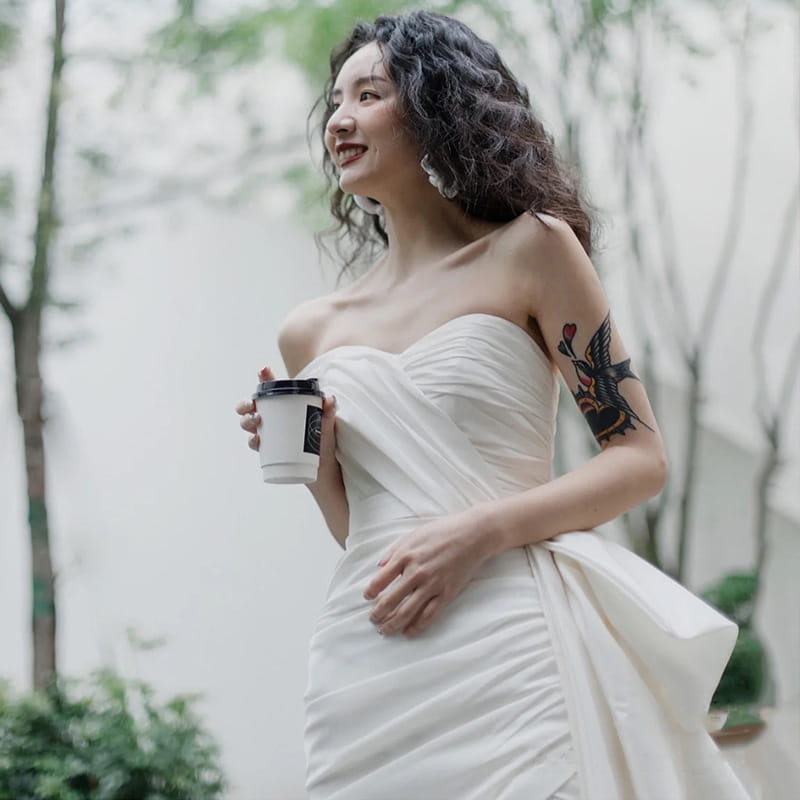 white strapless satin light wedding gown with ruched bodice and flowing skirt designed as a wedding gown short for women
