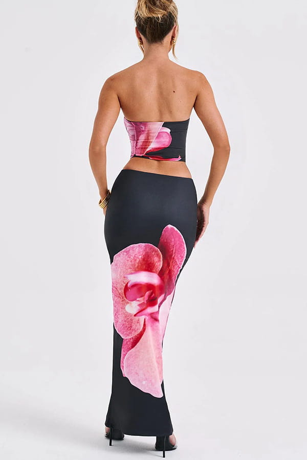 A black strapless corset top with vibrant pink orchid print paired with matching high-waisted leggings in a black orchid fashion vacation women’s skirt set featuring floral clothing skirts for fashion vacation.