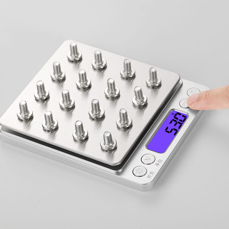 silver brushed stainless steel food portable mini pocket scale with blue display showing 5.30 grams and multiple stainless steel bolts on platform with control buttons for power and unit selection