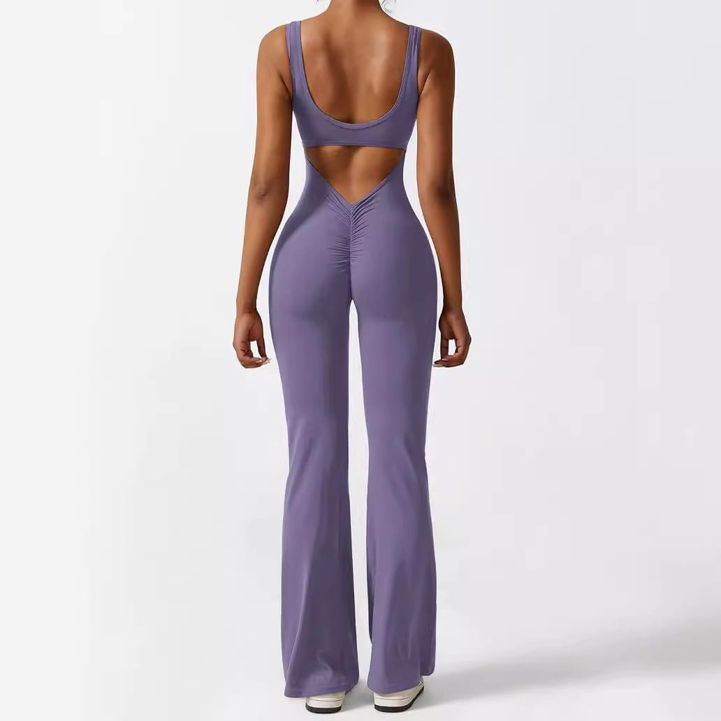 women sleeveless flare fitness yoga set in lavender featuring a form-fitting two-piece design with a cropped top and flared pants with an open back design shown from the back side.