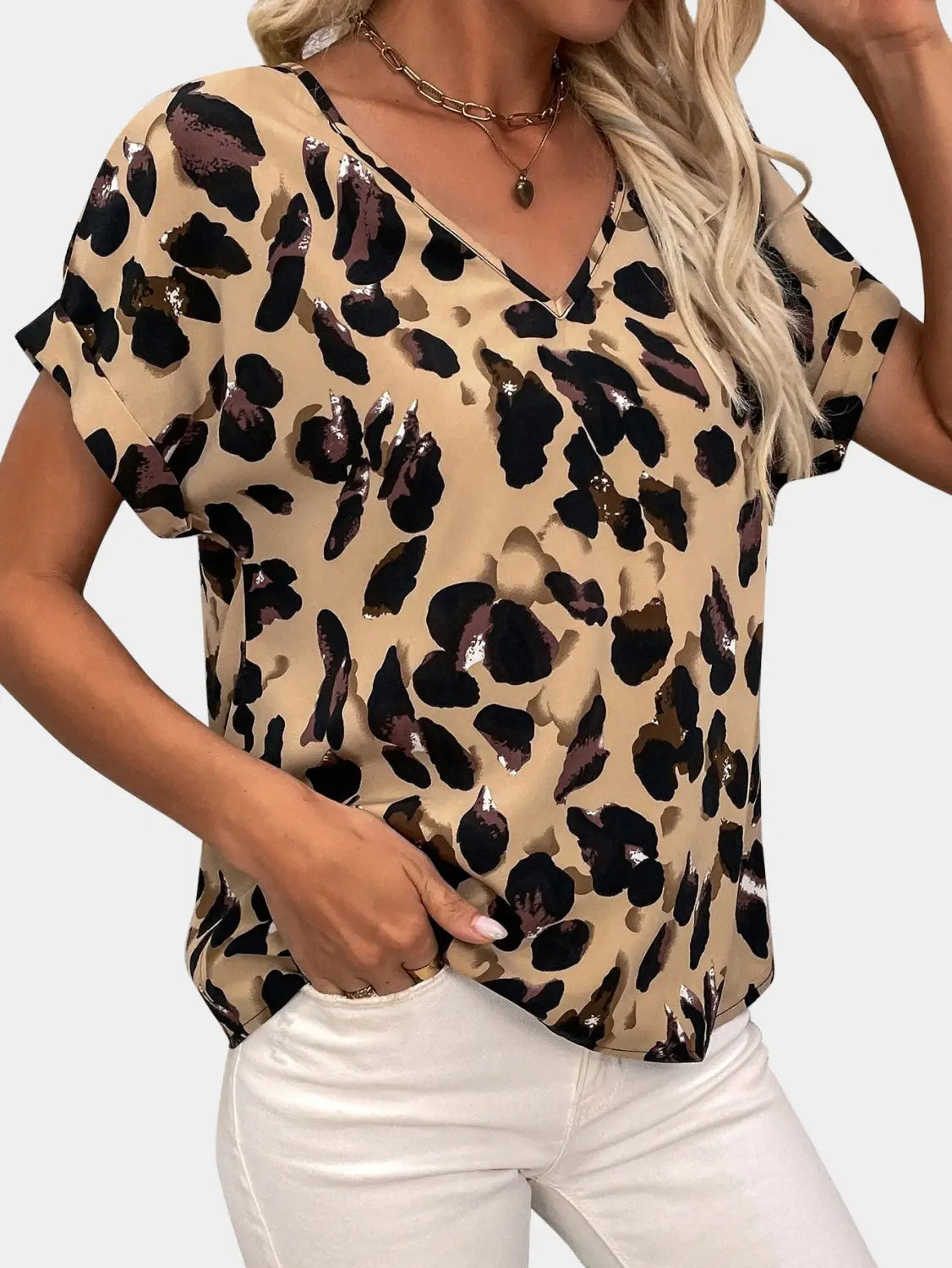 Beige leopard-print women’s clothing printed v-neck top with short flutter sleeves and geometric design.