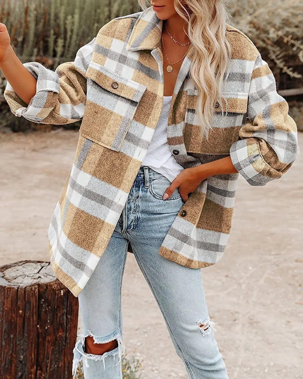 A cozy oversized plaid button flannel woolen shirt in beige and gray with a plaid pattern and rolled-up sleeves.