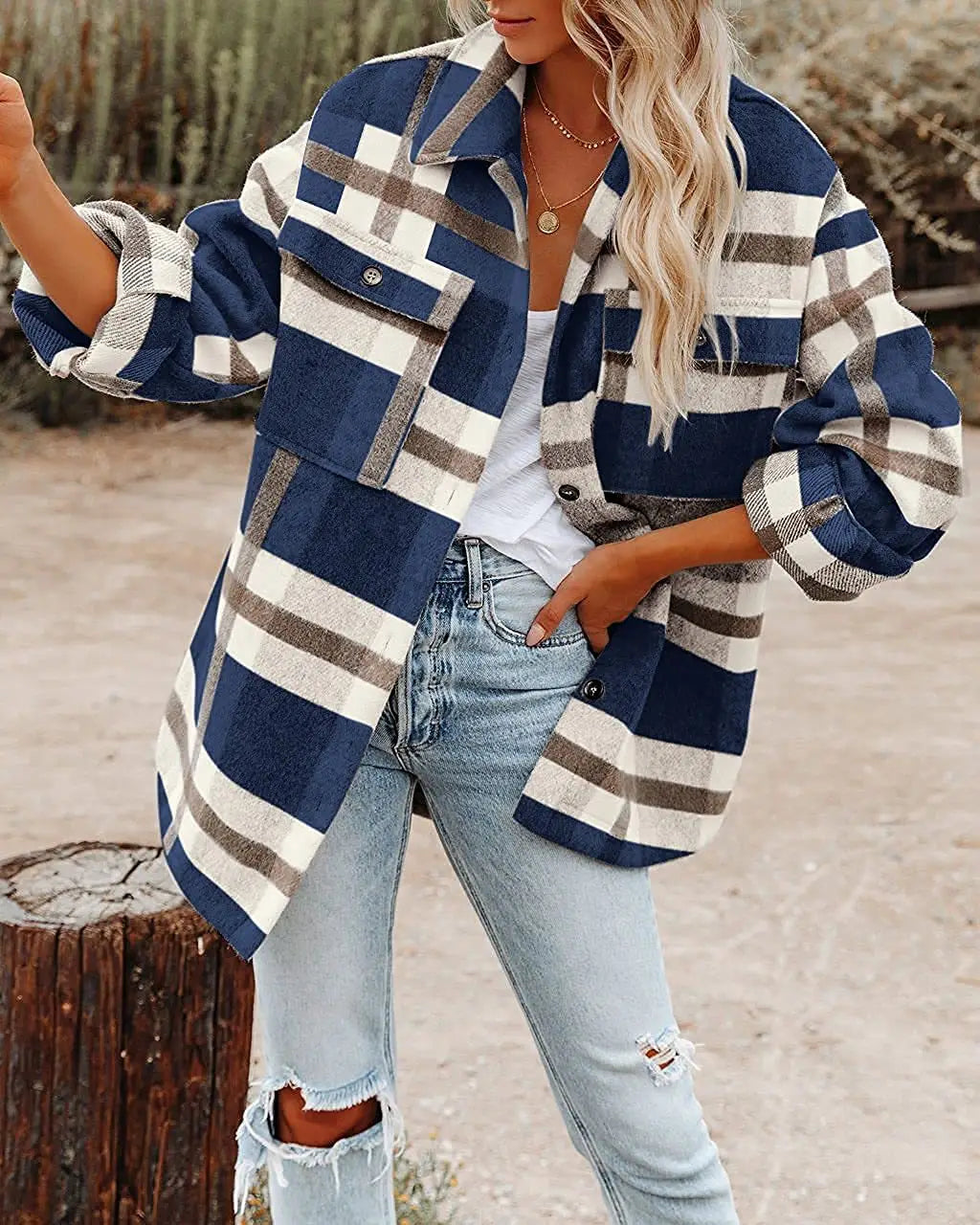 A cozy oversized plaid button flannel shirt in navy white and gray with rolled-up sleeves made from soft woolen material.