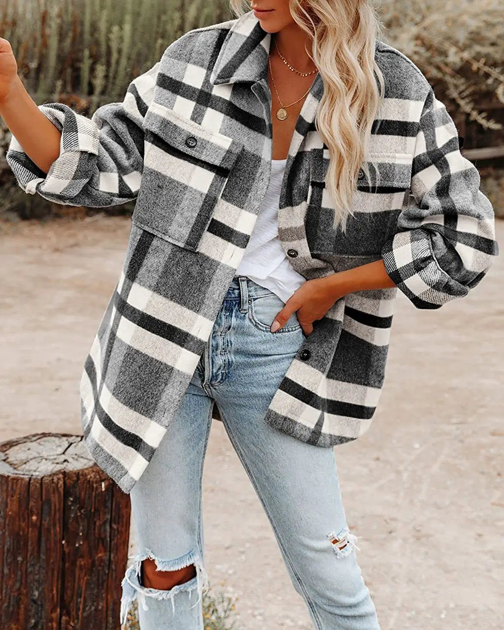 A cozy oversized plaid button flannel woolen shirt in black white and gray with buttoned chest pockets.