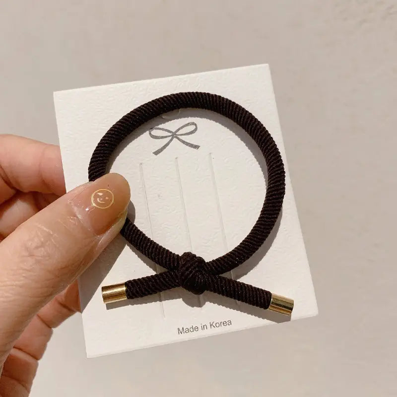 black braided wrist hair rope with high elasticity and gold-colored metal ends for secure hair styling