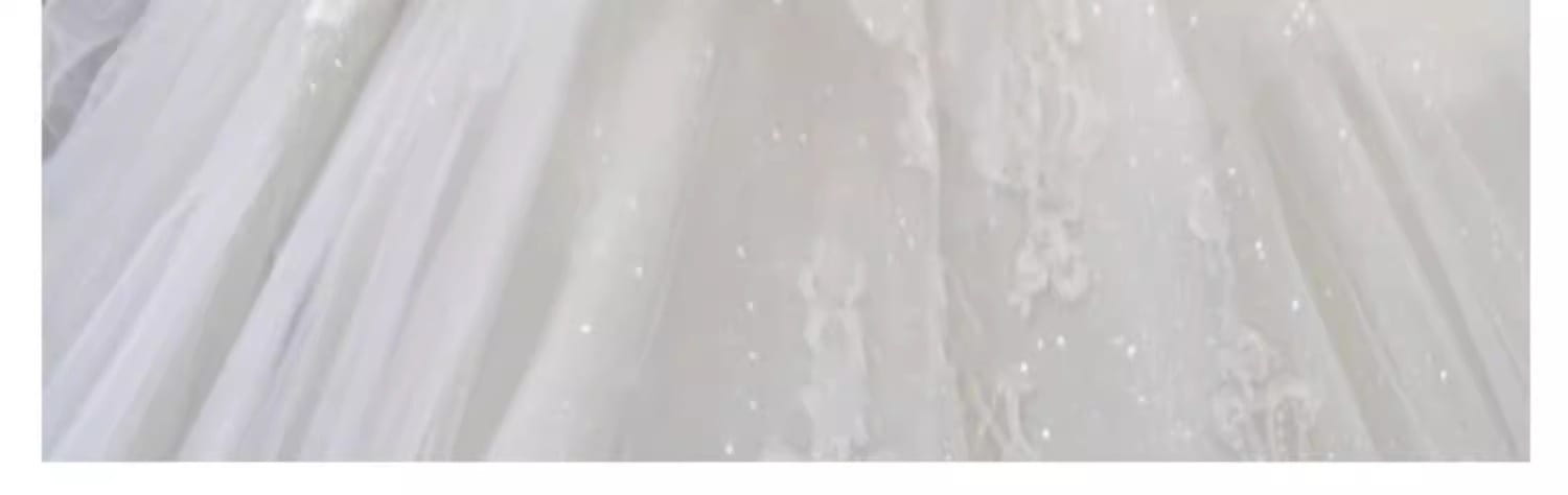 a delicate white lace bride main yarn long sleeve wedding gown with subtle floral embroidery and scattered sparkling embellishments in a french retro style