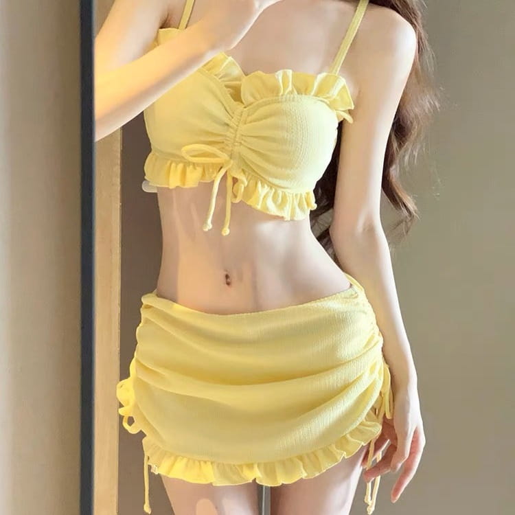 A vibrant yellow ruched fashion personality bikini set with delicate frills and matching drawstrings designed as a personality bikini split swimsuit.