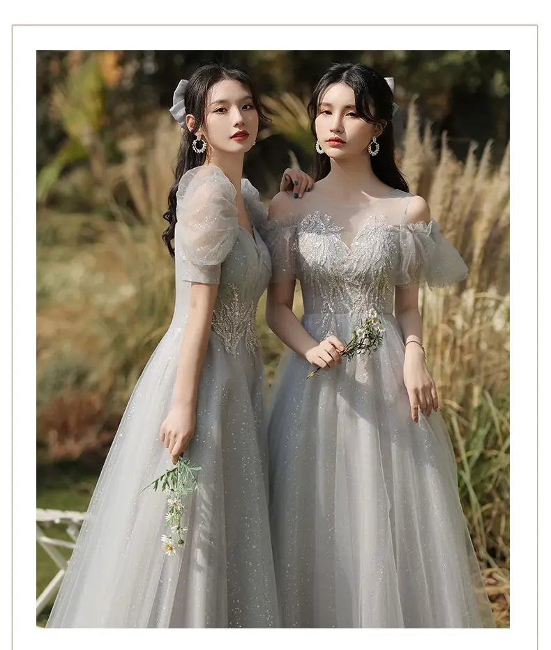 elegant silver gray tulle ballgown with sparkling embellishments and off-the-shoulder puffy sleeves designed as a sisters dress female perfect for formal occasions.