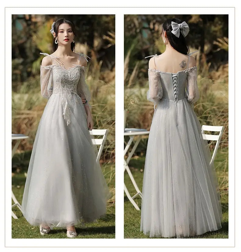 A delicate light gray off-the-shoulder sisters dress female made of tulle with sheer long sleeves and intricate beading on the bodice.