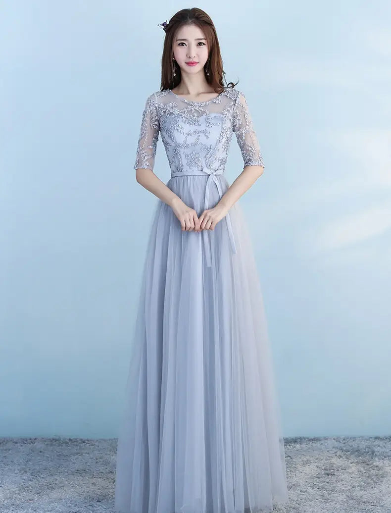 a long bridesmaid blue lace and tulle dress with three-quarter sleeves and a flowing skirt perfect for a bridesmaid blue wedding or blue wedding dress occasion