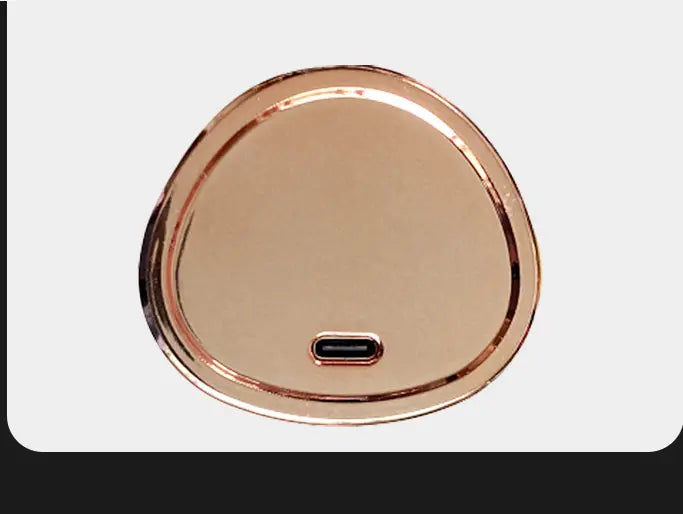 rose gold wireless rechargeable curling iron electric charging pad with oval shape sleek metallic finish and centered usb-c port