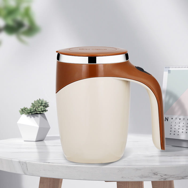 Cream-colored rechargeable model automatic stirring cup with a brown handle and lid, metallic rim, and insulated design for efficient beverage stirring.