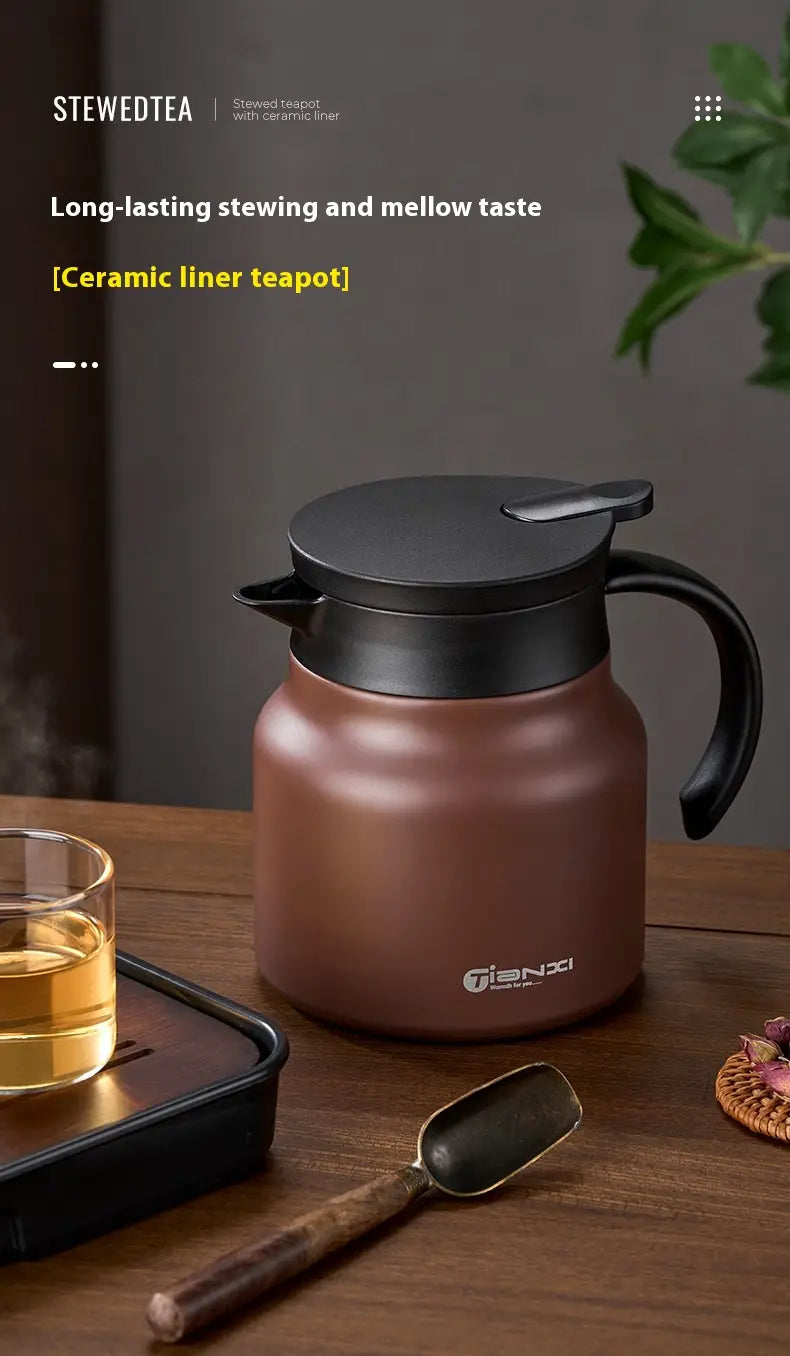 Brown ceramic-lined large capacity tea carafe with black lid and handle designed for tea water separation.