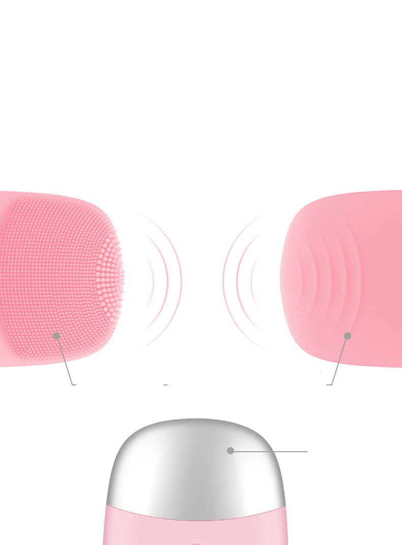 Mini silicone electric facial cleanser brush in pink silicone with a silver metallic base for gentle skin cleansing.