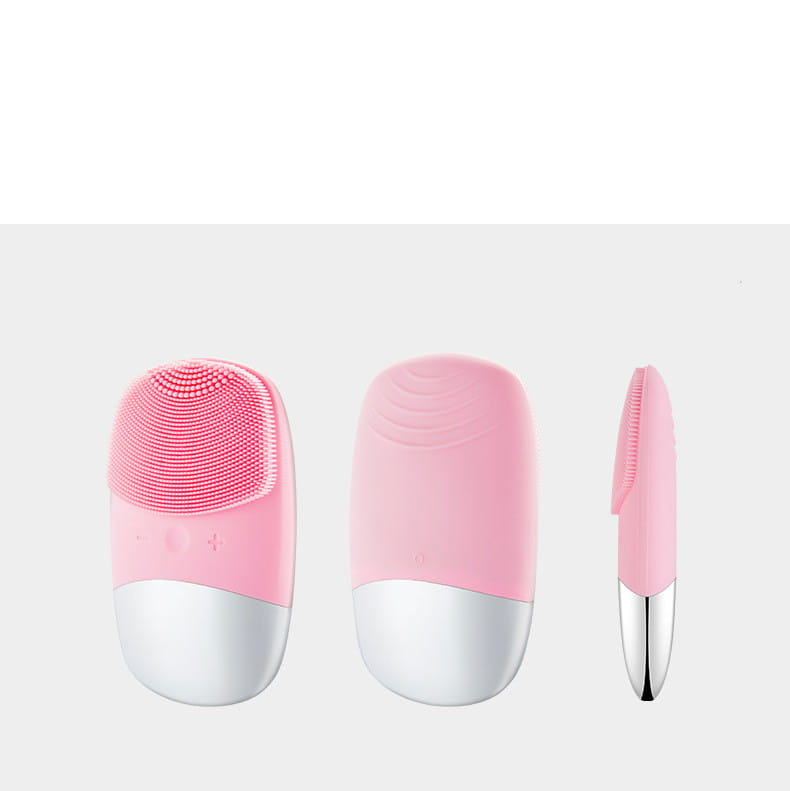 Mini silicone electric facial cleanser brush in pink and white with soft silicone bristles for gentle cleansing.