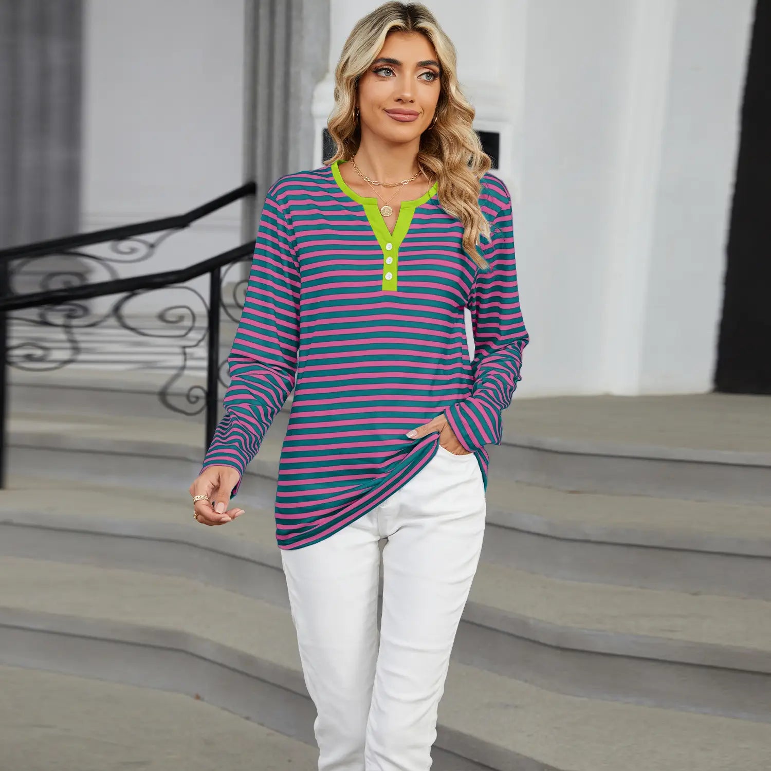 women’s v-neck striped loose henley top featuring long sleeves with purple and teal stripes and a vibrant lime green collar and placket