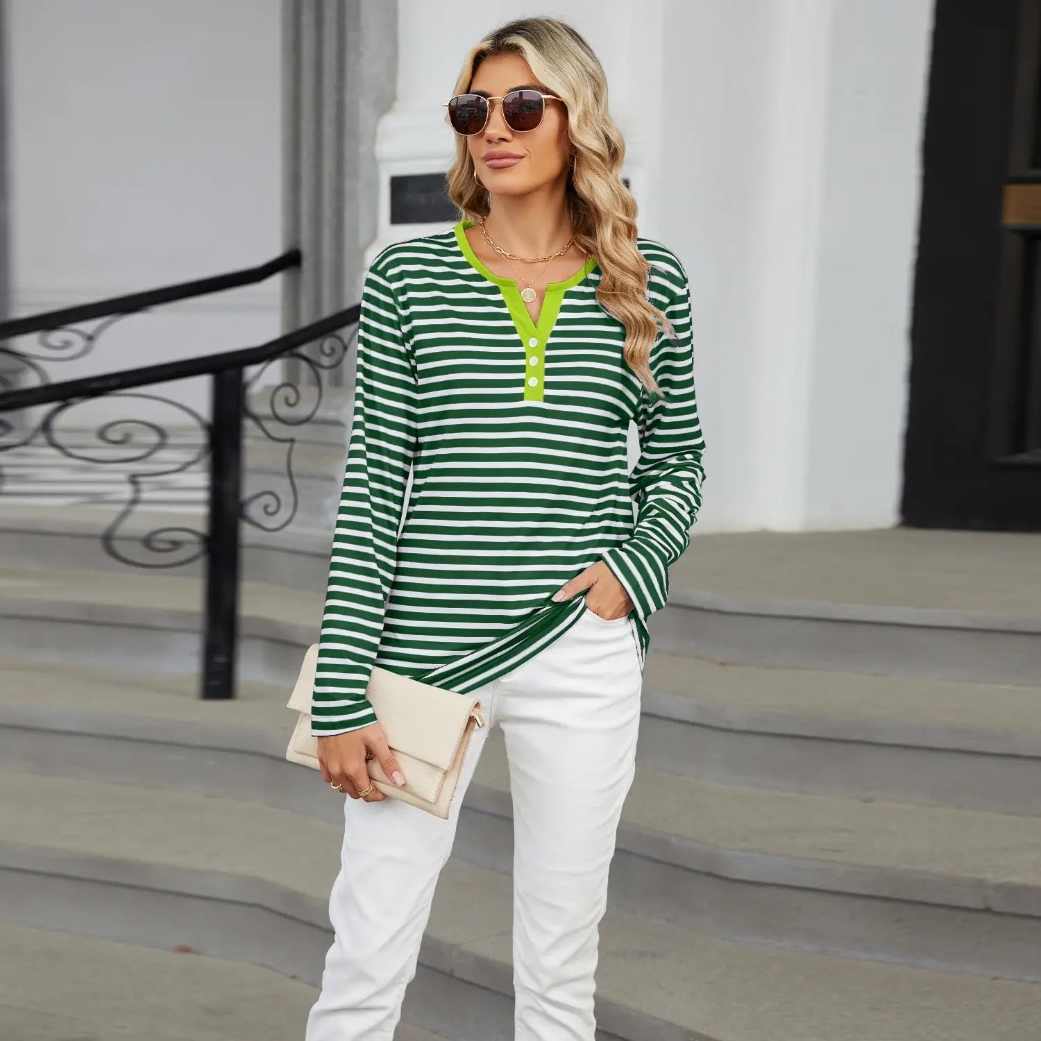 women’s v-neck striped loose long-sleeve henley top in green and white stripes with a bright lime green collar.