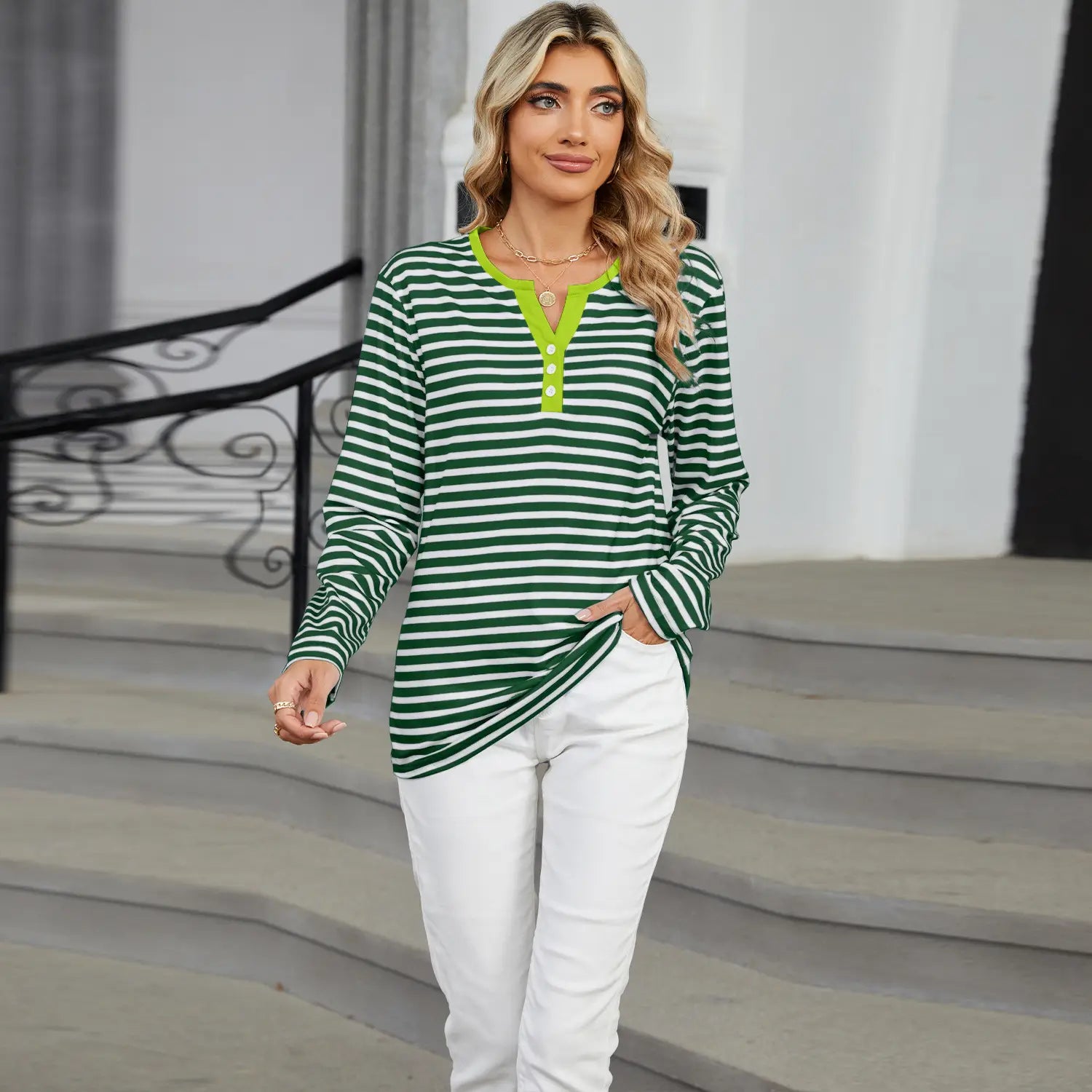 Women’s v-neck striped loose henley top featuring green and white stripes with a neon green collar and button placket.