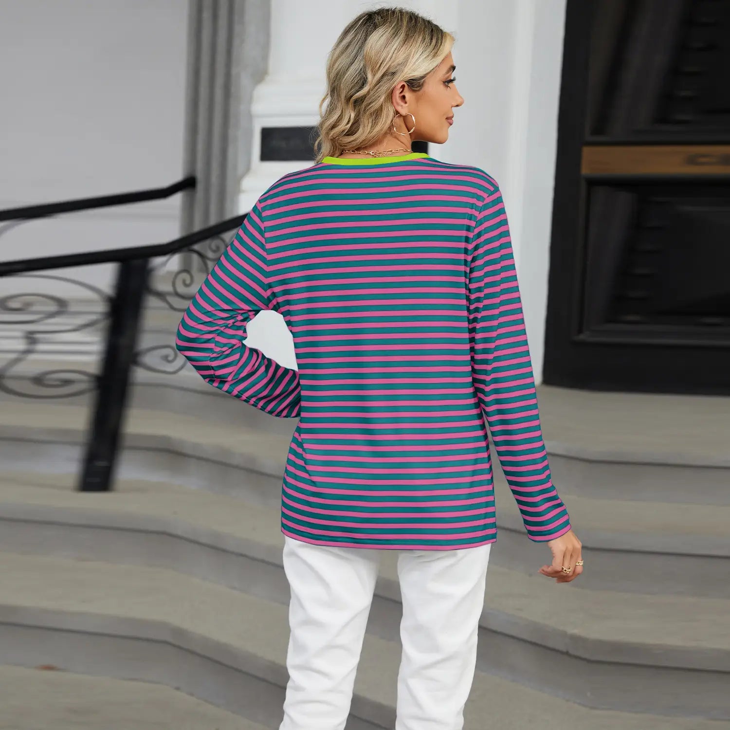 Women’s v-neck striped loose long-sleeved top featuring horizontal stripes in shades of purple and teal with a lime green trim on the round neckline.