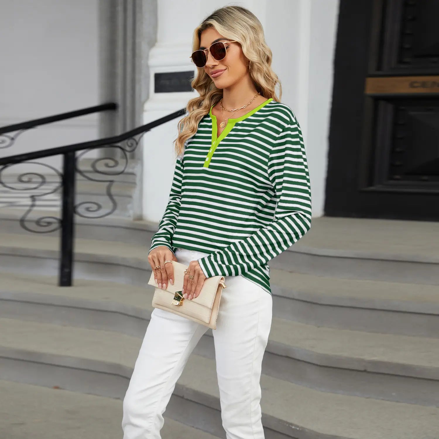 women’s v-neck striped loose henley top featuring green and white stripes with a neon yellow placket and long sleeves.