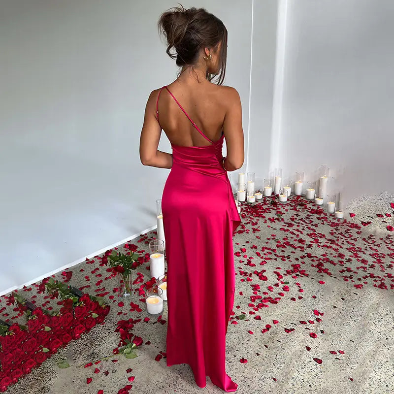 a vibrant fuchsia satin slip dress with a backless design and thin straps shown from the back complements the sexy one-shoulder backless slit satin gown collection.