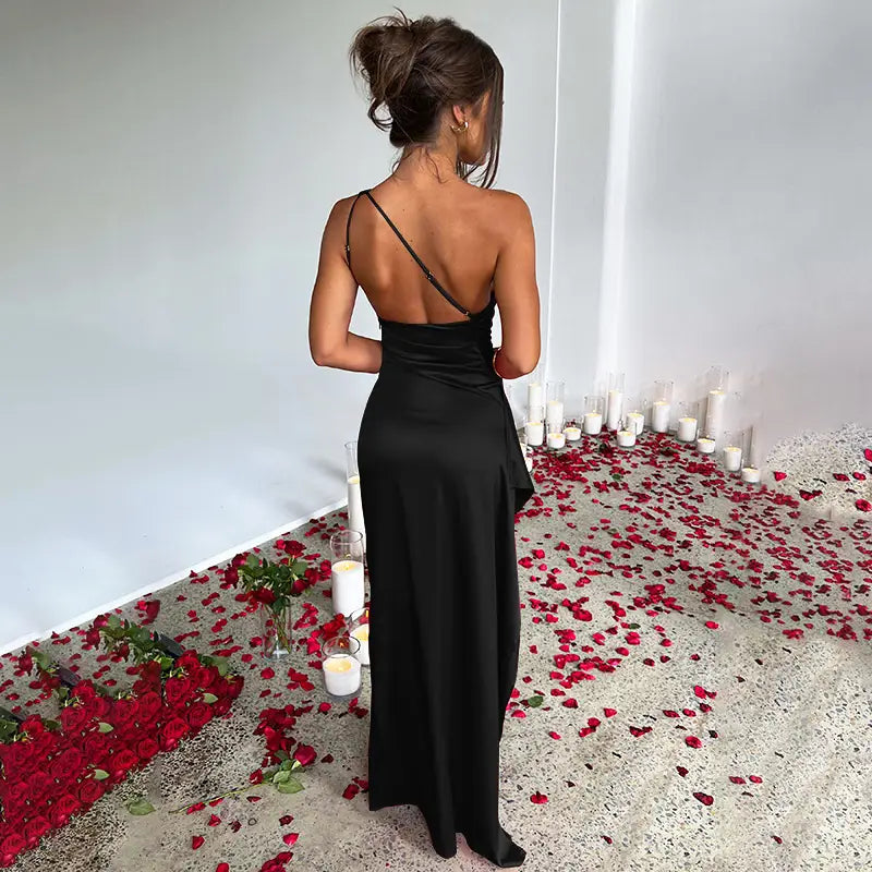 black satin slip dress with thin shoulder straps and backless design shown from the back highlighting the sexy one-shoulder backless slit feature