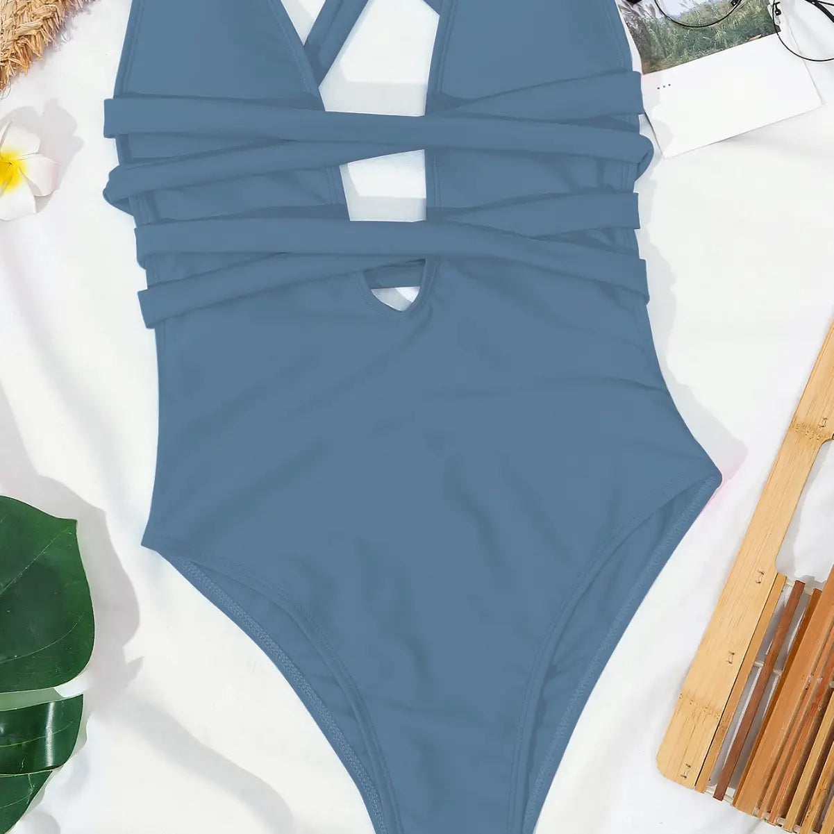 A sleek slate blue one-piece fashion pure color swimsuit featuring a flattering cutout design and crossed straps perfect for a color bikini swimsuit collection.