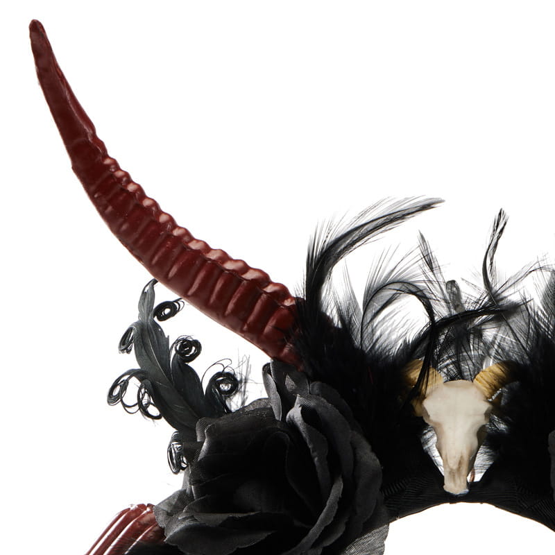 A gothic dark devil horn skull antelope horn headband featuring a striking black feathered design with a glossy red dark devil horn and an ornate skull accent.