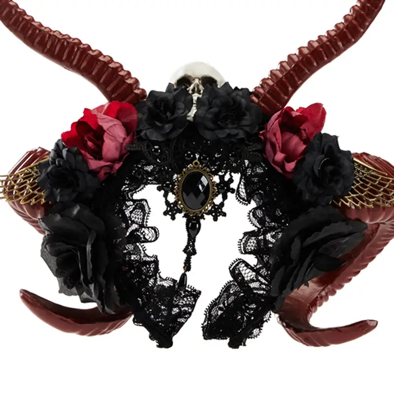 Elegant gothic dark devil horn headband featuring black lace, burgundy and red fabric roses, ornate antelope horns, a central dark gemstone pendant, and delicate gold mesh accents.