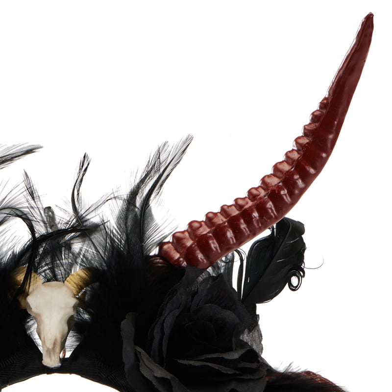 a gothic dark devil antelope horn headband featuring a glossy red ridged horn adorned with black feathers and a white skull centerpiece