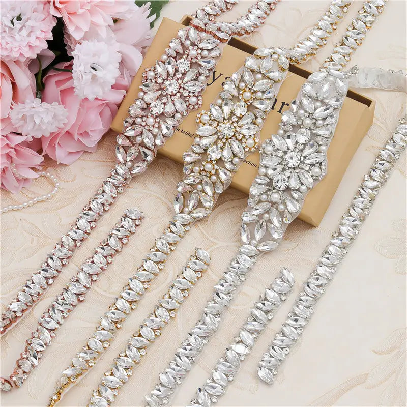 Silver rhinestone applique wedding sash with intricate floral design and pearl accents for wedding dress waist jewelry.