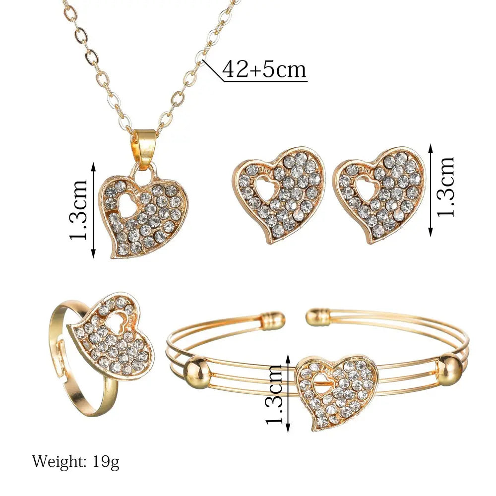 gold-toned heart shaped love jewelry set featuring sparkling clear rhinestone crystals on each piece.