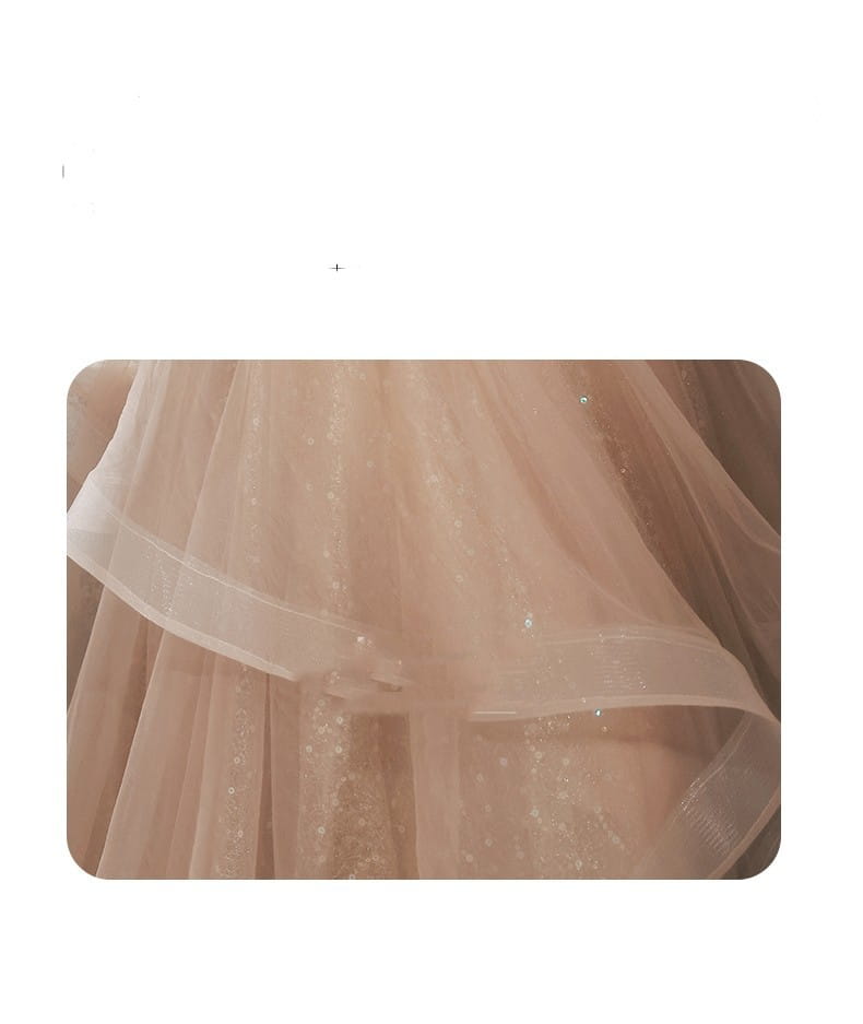 blush beaded tulle luxury evening dress featuring a delicate blush-pink tulle skirt with subtle glittering embellishments and a soft layered ruffle design for an elegant luxury evening look
