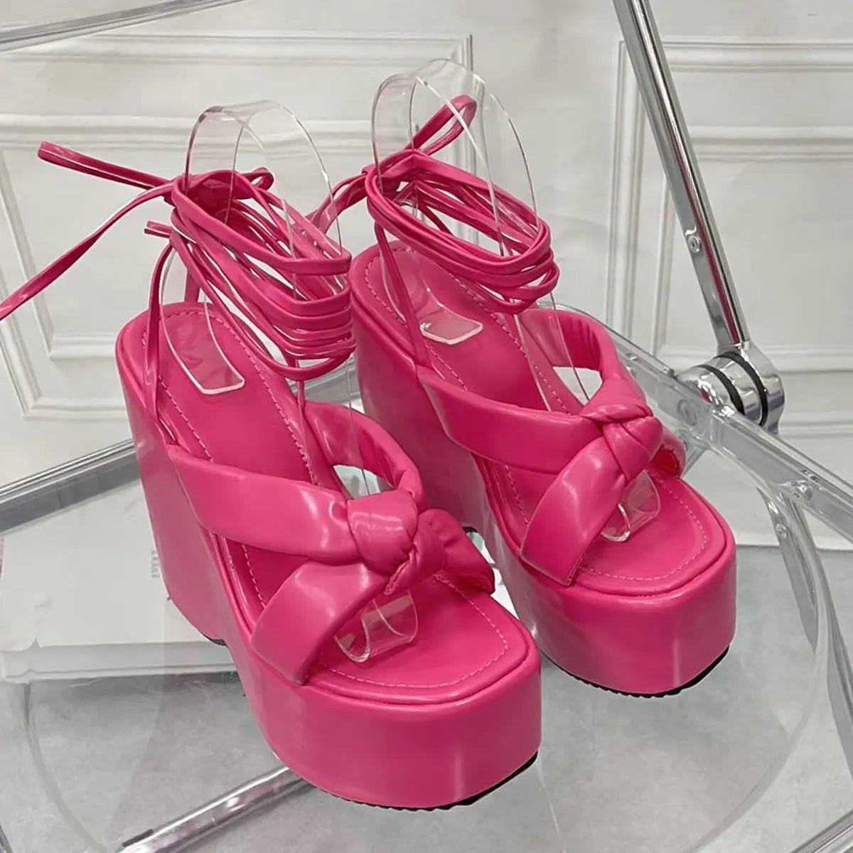 pink platform wedge high heel sandals with glossy patent leather straps and a prominent bow detail