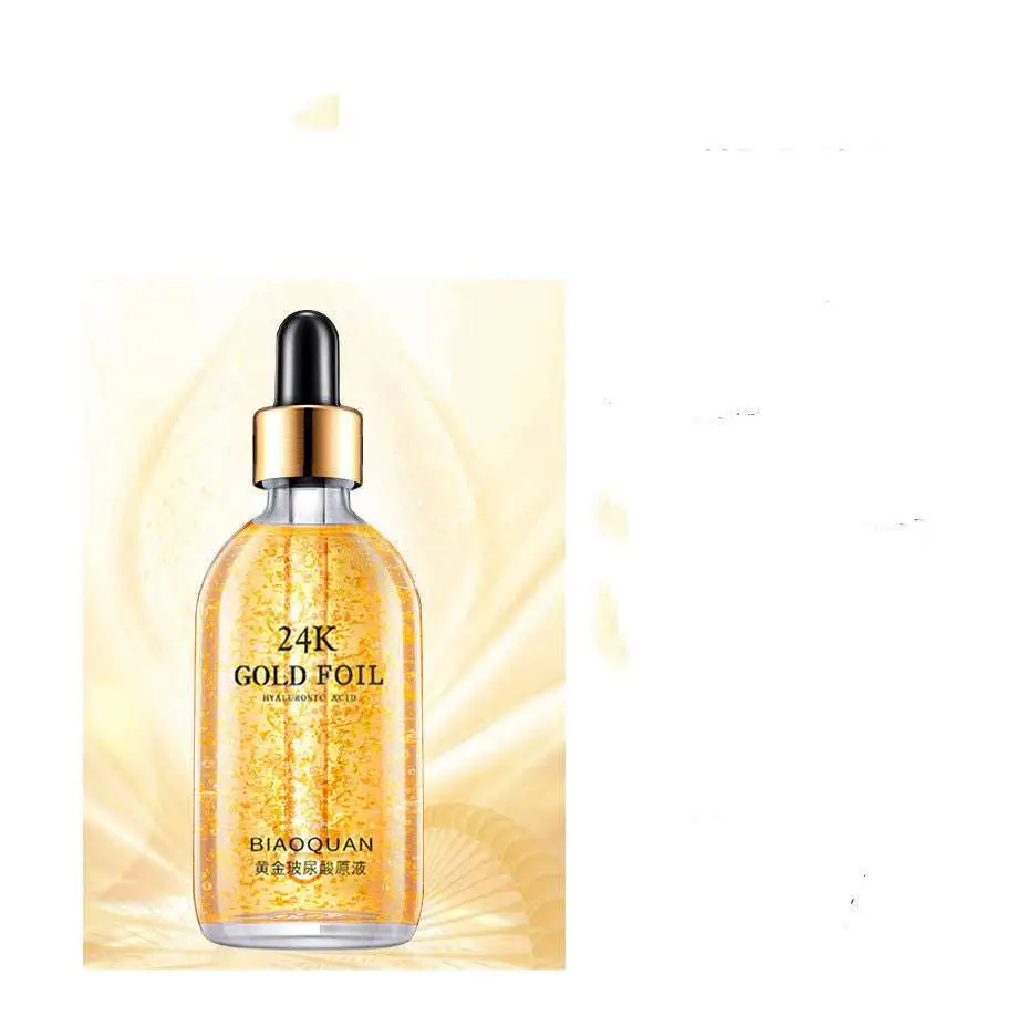 A transparent glass bottle of 24k gold pure hyaluronic acid essence serum with gold-colored dropper cap by biaoquan