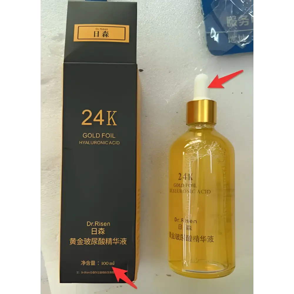 A golden-hued transparent glass bottle of 24k gold pure hyaluronic acid essence serum with gold foil cap and dropper