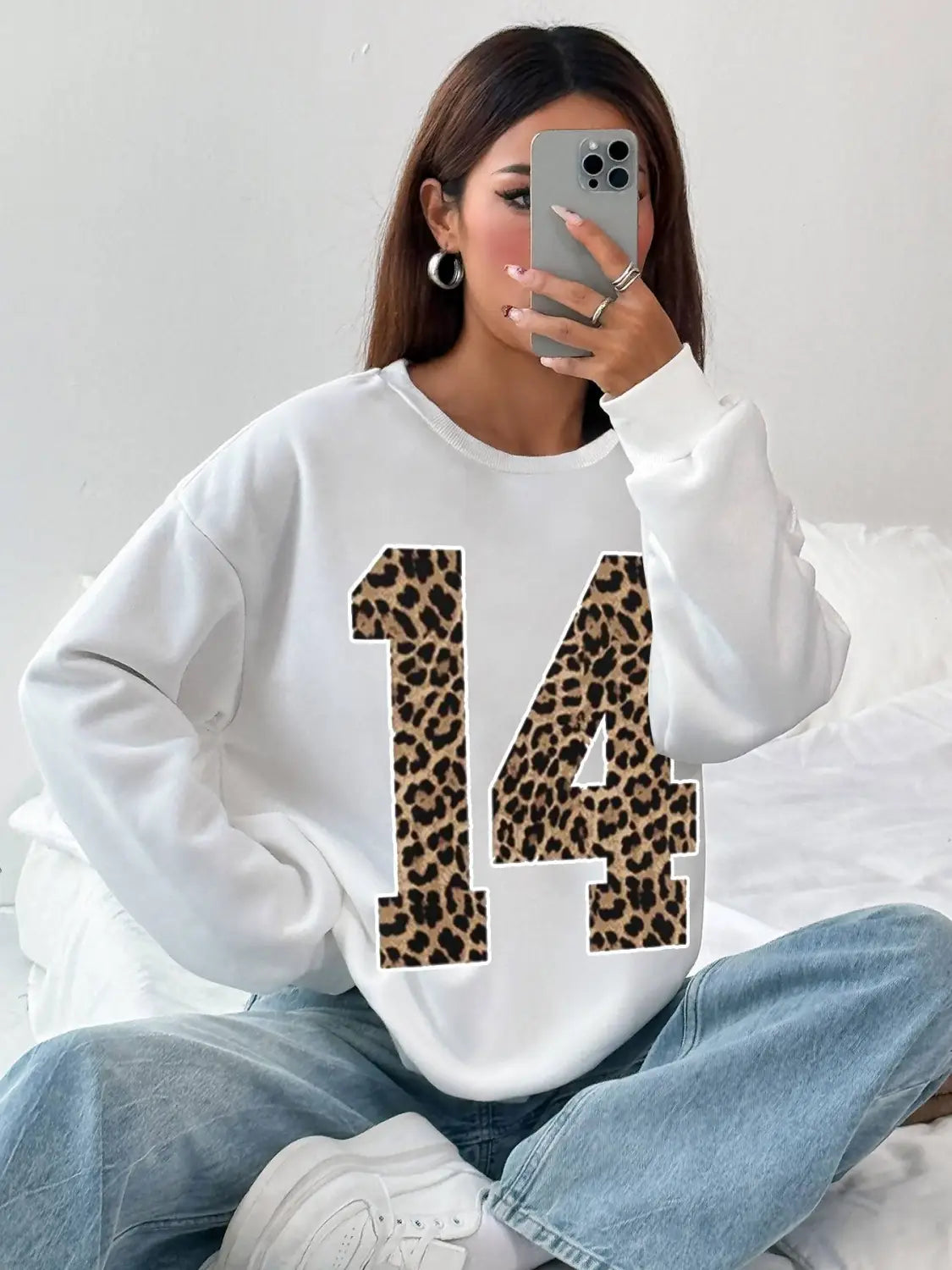 White crew neck sweatshirt featuring a bold black leopard-print number 14 across the front.