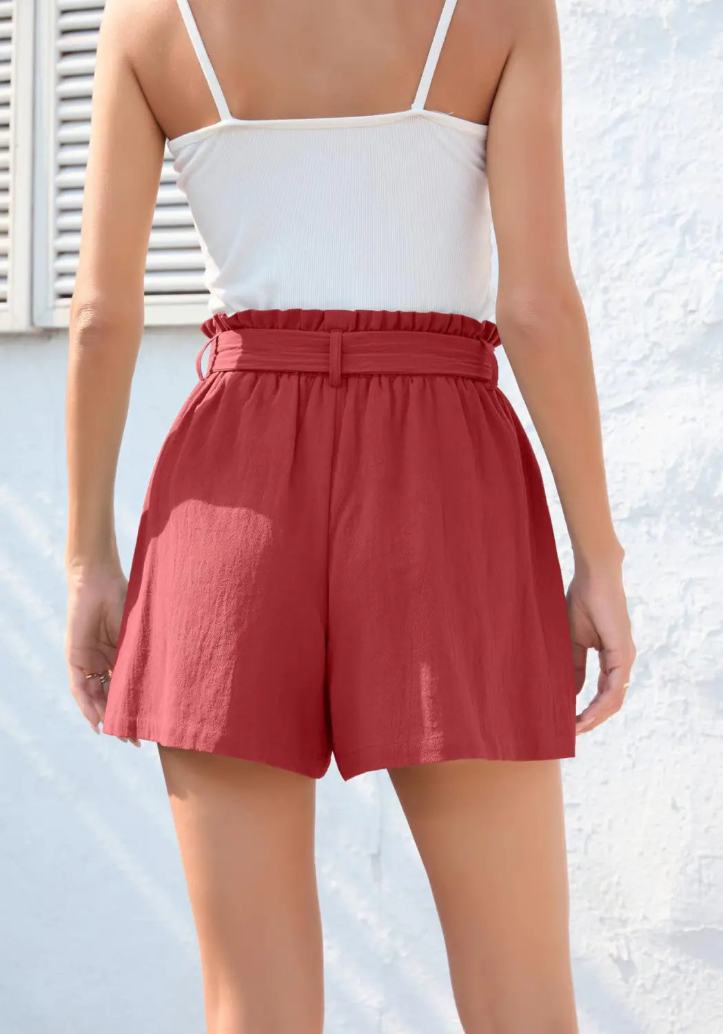 red high-waisted shorts with a gathered waistband and matching belt featuring a fashion ruffle bow waist tie detail perfect for stylish casual wear